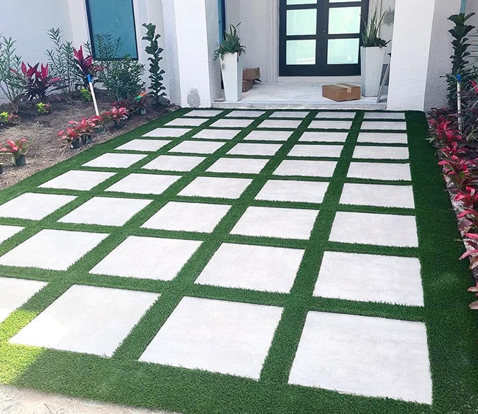 Fake grass around stone pavers at a Wellington, FL, house