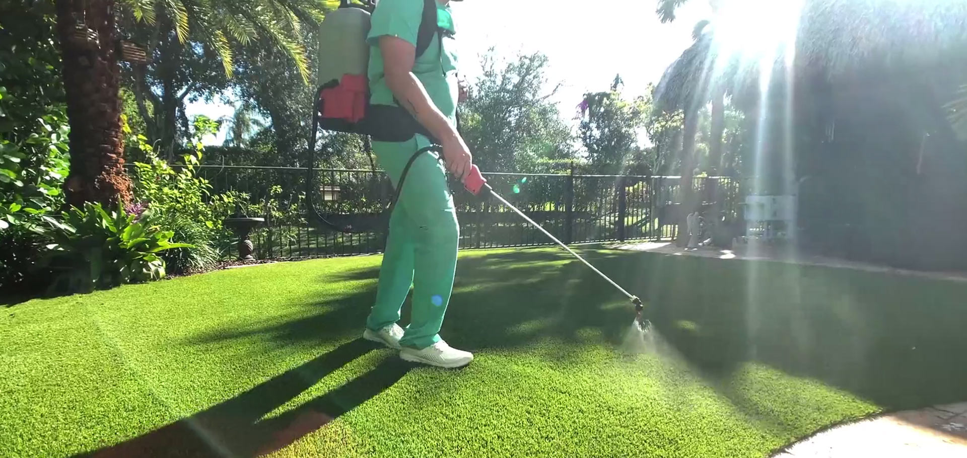 Spraying synthetic grass in Palm beach Gardens as a part of turf maintenance