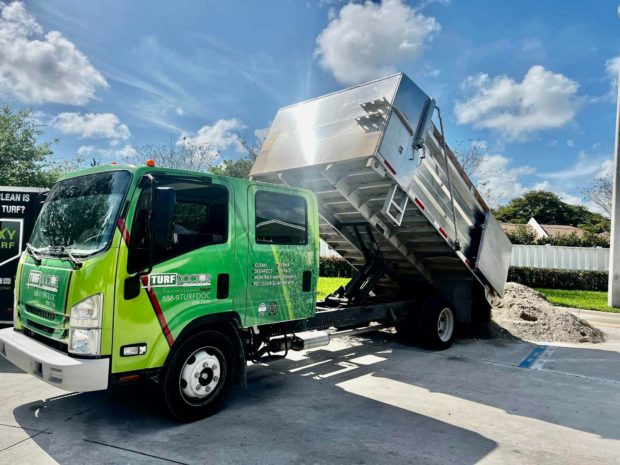 TurfDoctor truck unloading equipment for synthetic turf installation in Delray Beach, FL