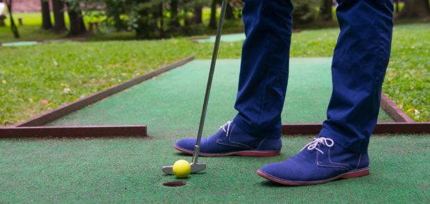 Man Putting on Putting Green Artificial Grass in Boca Raton, Boynton Beach, Delray Beach, Lantana, Palm Beach Gardens, Wellington