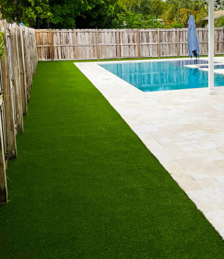 a fenced in backyard with a pool and Synthetic Grass in Delray Beach, Palm Beach Gardens, Boynton Beach, Wellington, Boca Raton, Lantana, FL